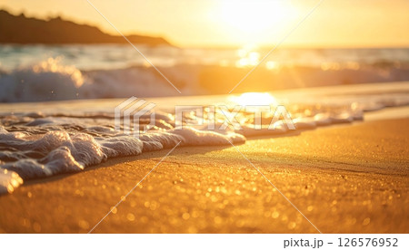 Warm sunlight paints the desert landscape and mountain horizons, with the sun setting over calm ocean waves or rising above sandy beaches under a beautiful sky 126576952