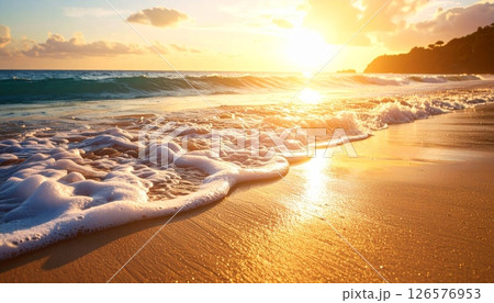 Warm sunlight paints the desert landscape and mountain horizons, with the sun setting over calm ocean waves or rising above sandy beaches under a beautiful sky 126576953