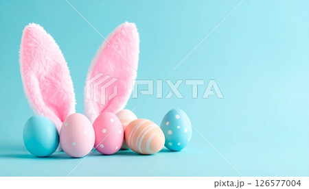 Pink Easter bunny and colorful eggs in green grass make a cute spring holiday decoration 126577004