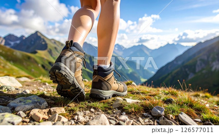Active woman hiking a summer mountain landscape with a clear sky Active woman hiking a summer mountain landscape with a clear sky 126577011
