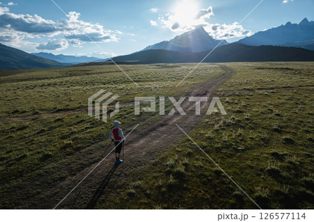 Aerial view of woman trail runner in high altitude mountains 126577114