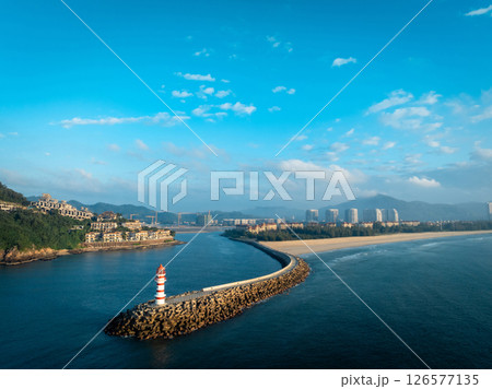 Aerial view of red and white striped lighthouse on seaside Aerial view of red and white striped lighthouse on seaside 126577135