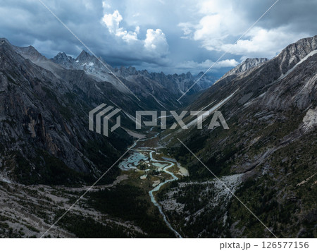 Aerial view of beautiful high altitude forest canyon and snow capped mountain landscape 126577156