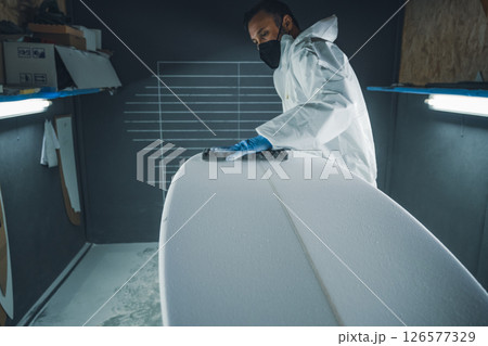 Shaper working on surf board 126577329