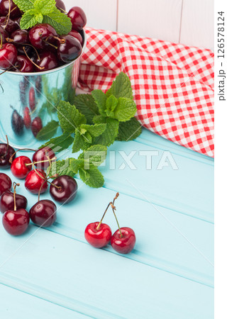 Cherries in blue wooden table 126578124