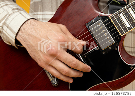 A man plays a beautiful guitar close-up A man plays a beautiful guitar close-up 126578785