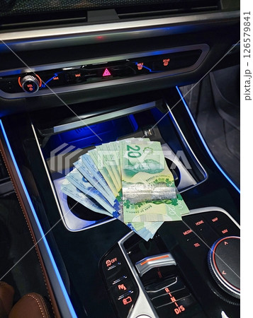 Cash Stash in a Car Console Twenty Dollar Bills in Plain View, Financial Security 126579841
