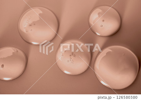 Cosmetic transparent gel drops in mocha mousse color 126580380
