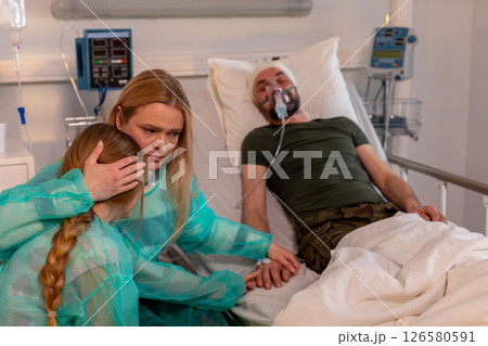 An emotional hospital scene highlights the crucial support and care from family in tough times An emotional hospital scene highlights the crucial support and care from family in tough times 126580591