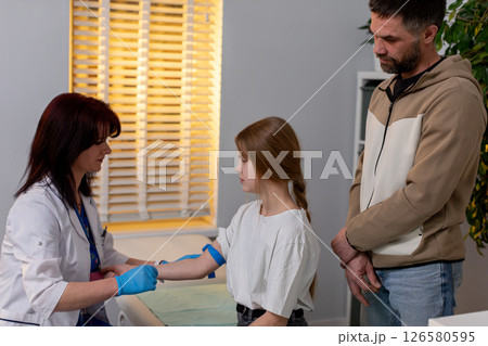 A young child is at the Doctors Office for a blood test with a parent for support A young child is at the Doctors Office for a blood test with a parent for support 126580595