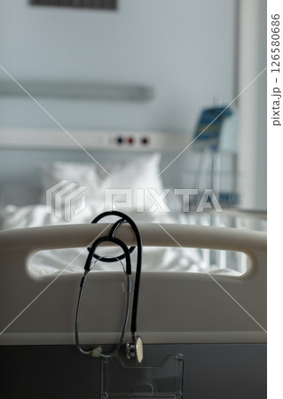 A Hospital Scene featuring a Stethoscope and a Patient Bed within a Medical Setting 126580686