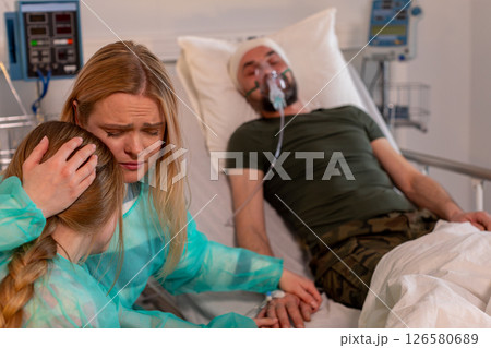 A heartfelt hospital scene highlights the vital family support in times of crisis and healing 126580689