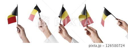 The Belgium flag in hand in different angles on a white background The Belgium flag in hand in different angles on a white background 126580724