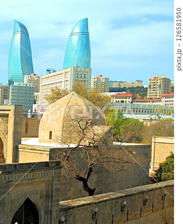 Baku city, Azerbaijan, view of historic mosques and walls of the Shirvanshahs Palace in the Old City and modern glass Flame Towers 126581950