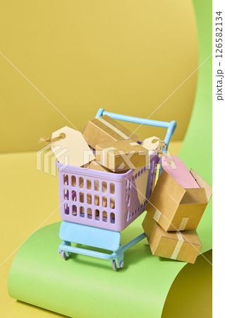 A purple cart overflowing with cardboard boxes on a curved yellow-green background, symbolizing product overload in retail or delivery scenarios. Vertical frames for social media advertising design A purple cart overflowing with cardboard boxes on a curved yellow-green background, symbolizing product overload in retail or delivery scenarios. Vertical frames for social media advertising design 126582134