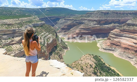 Woman Photographs Scenic Canyon River Bend on Sunny Day Woman Photographs Scenic Canyon River Bend on Sunny Day 126582337