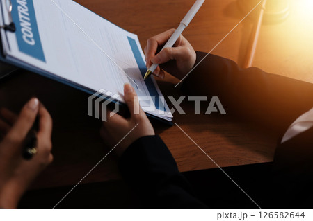 Judge gavel with Justice lawyers having team meeting at law firm background. Concepts of Law and Legal services. 126582644