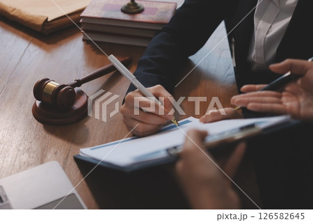 Judge gavel with Justice lawyers having team meeting at law firm background. Concepts of Law and Legal services. Judge gavel with Justice lawyers having team meeting at law firm background. Concepts of Law and Legal services. 126582645