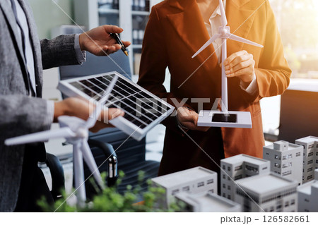 Discussion among businesspeople on the latest developments in solar cell panel technology and Solar Energy Environment city Concept. Discussion among businesspeople on the latest developments in solar cell panel technology and Solar Energy Environment city Concept. 126582661