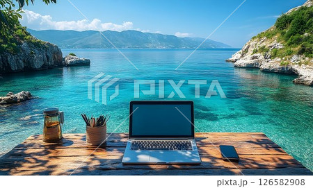 Laptop and Phone on Wooden Desk Overlooking Turquoise Sea and Di 126582908