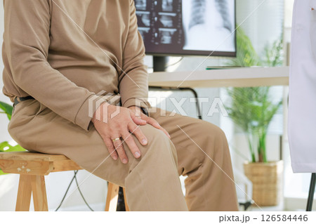 Doctor examining senior patient for osteoarthritis and knee pain during orthopedic checkup in hospital Doctor examining senior patient for osteoarthritis and knee pain during orthopedic checkup in hospital 126584446