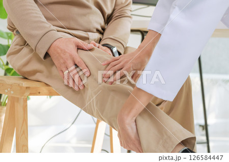 Doctor examining senior patient for osteoarthritis and knee pain during orthopedic checkup in hospital Doctor examining senior patient for osteoarthritis and knee pain during orthopedic checkup in hospital 126584447