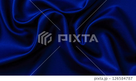 Smooth royal blue satin fabric with soft curves folds and shadows perfect for elegant branding design or fashion packaging 126584787