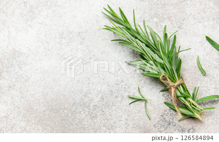 Fresh rosemary sprigs tied with twine on stone surface 126584894