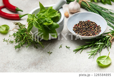 Fresh herbs and spices creating culinary masterpiece on table 126584895