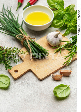 Fresh chives, herbs and spices with olive oil on kitchen table Fresh chives, herbs and spices with olive oil on kitchen table 126584896