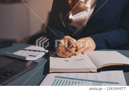 Expert woman asian female people review data number costing managerial account prepare monthly actual cost variance report at tax audit office. ESG sheet budget control ERP process service project. 126584977