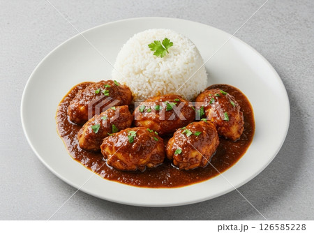 Moambe chicken with rice and parsley 126585228