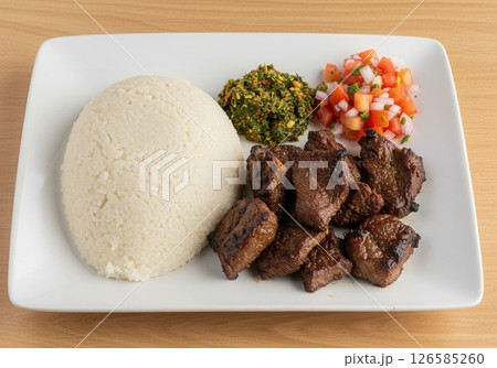 Tanzania Ugali Nyama Choma with greens and tomato relish Tanzania Ugali Nyama Choma with greens and tomato relish 126585260