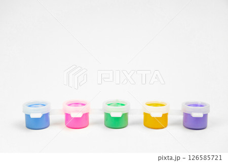 Plastic jars with paints for drawing. School props for creativity 126585721