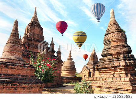 Balloon flight, famous tourist attraction of Bagan, Myanmar. Air balloons and ancient stupas in archaeological zone, Bagan, Burma. Topic of vacation, travel, trip abroad on vacation, cruises and tours 126586685
