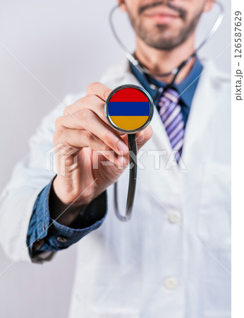 Armenia health and medical insurance concept. Armenia healthcare system, doctor holding stethoscope Armenia health and medical insurance concept. Armenia healthcare system, doctor holding stethoscope 126587629