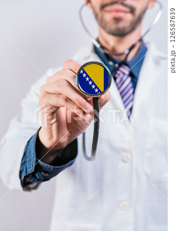 Bosnia health and medical insurance concept. Bosnia healthcare system, doctor holding stethoscope Bosnia health and medical insurance concept. Bosnia healthcare system, doctor holding stethoscope 126587639