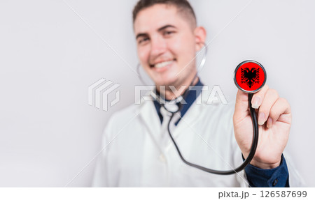 Doctor showing stethoscope with Albania flag. Albania national healthcare concept 126587699