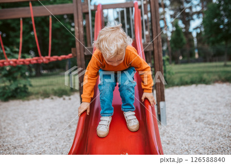 Little boy getting ready to slide 126588840
