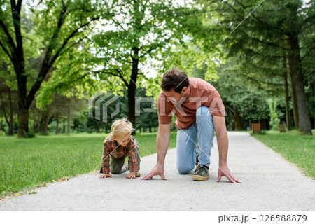 Father lining up to have a running race with his little son. 126588879