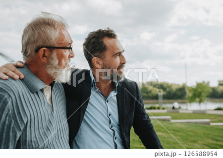 Father and adult son sharing a peaceful moment together. 126588954
