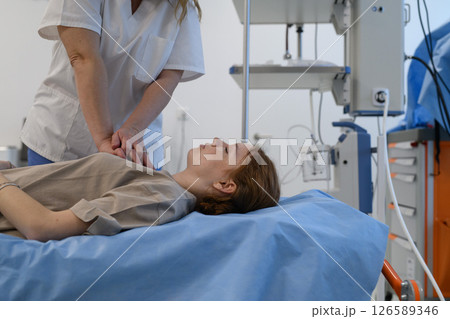 Doctors performing CPR on teenage patient in critical condition 126589346