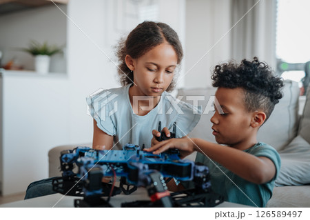 Kids playing with drone at home. Kids playing with drone at home. 126589497