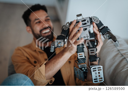 Handsome engineer student working on robot project at home. 126589500