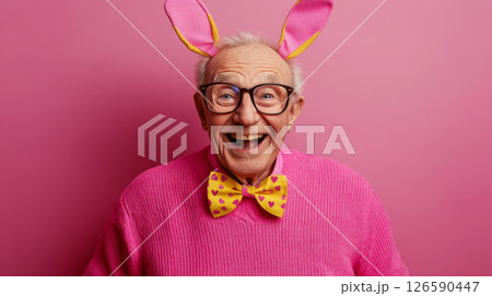 Elderly Man in Bunny Ears Laughing on Pink Background 126590447