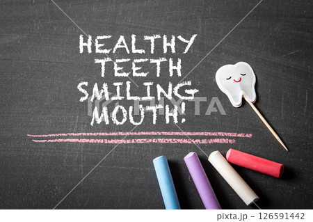 Healthy Teeth Smiling Mouth. Chalkboard Message with Happy Tooth and Colorful Chalk Sticks 126591442