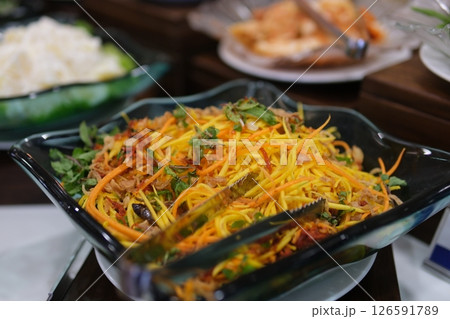 Mix the ingredients to make mango salad. 126591789