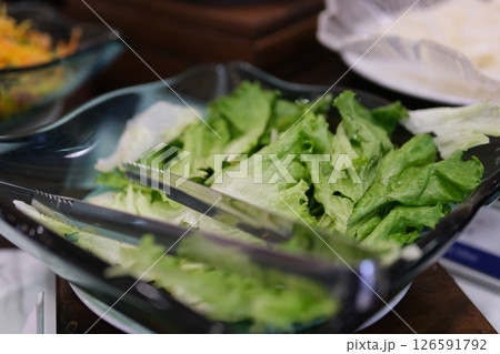 Preparing a fresh salad at the local salad bar in the afternoon Preparing a fresh salad at the local salad bar in the afternoon 126591792