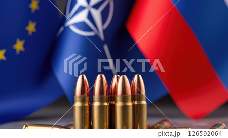 A powerful visual juxtaposes national flags against a backdrop of ammunition symbolizing conflict and military preparedness in a tense geopolitical landscape. 126592064