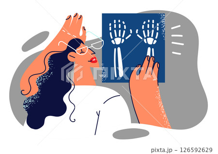 Woman doctor examines x-ray shot of hands of person injured or suffering from carpal tunnel syndrome Woman doctor examines x-ray shot of hands of person injured or suffering from carpal tunnel syndrome 126592629